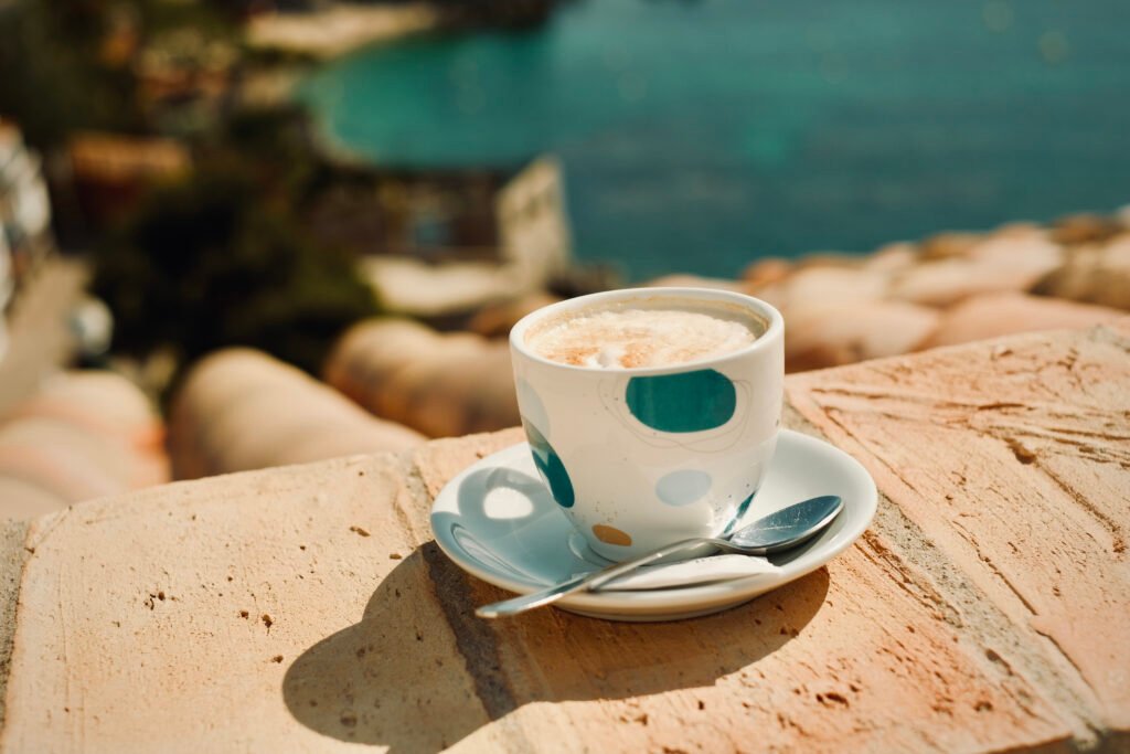 Hotel Sant Roc, Calella de Palafrugell: taza de café sobre la barandilla de la terraza