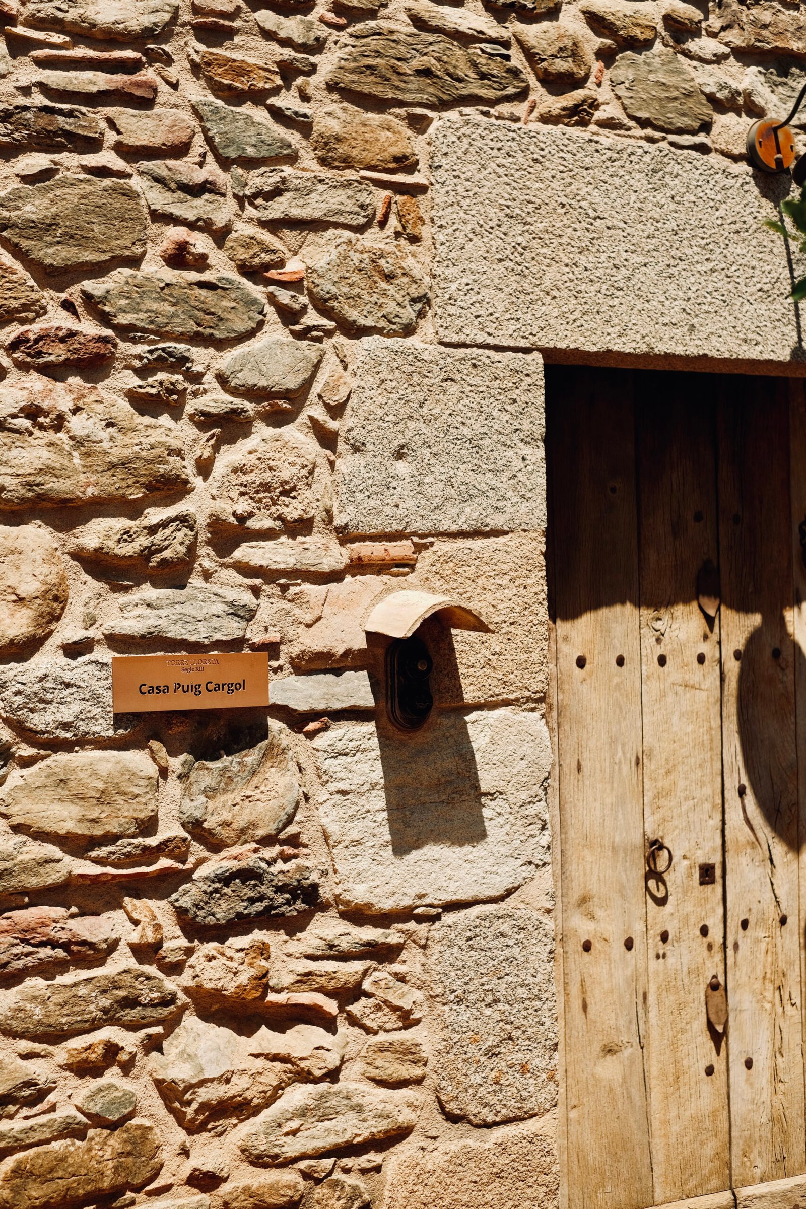 Torre Lloreta: muro de piedra con puerta de madera